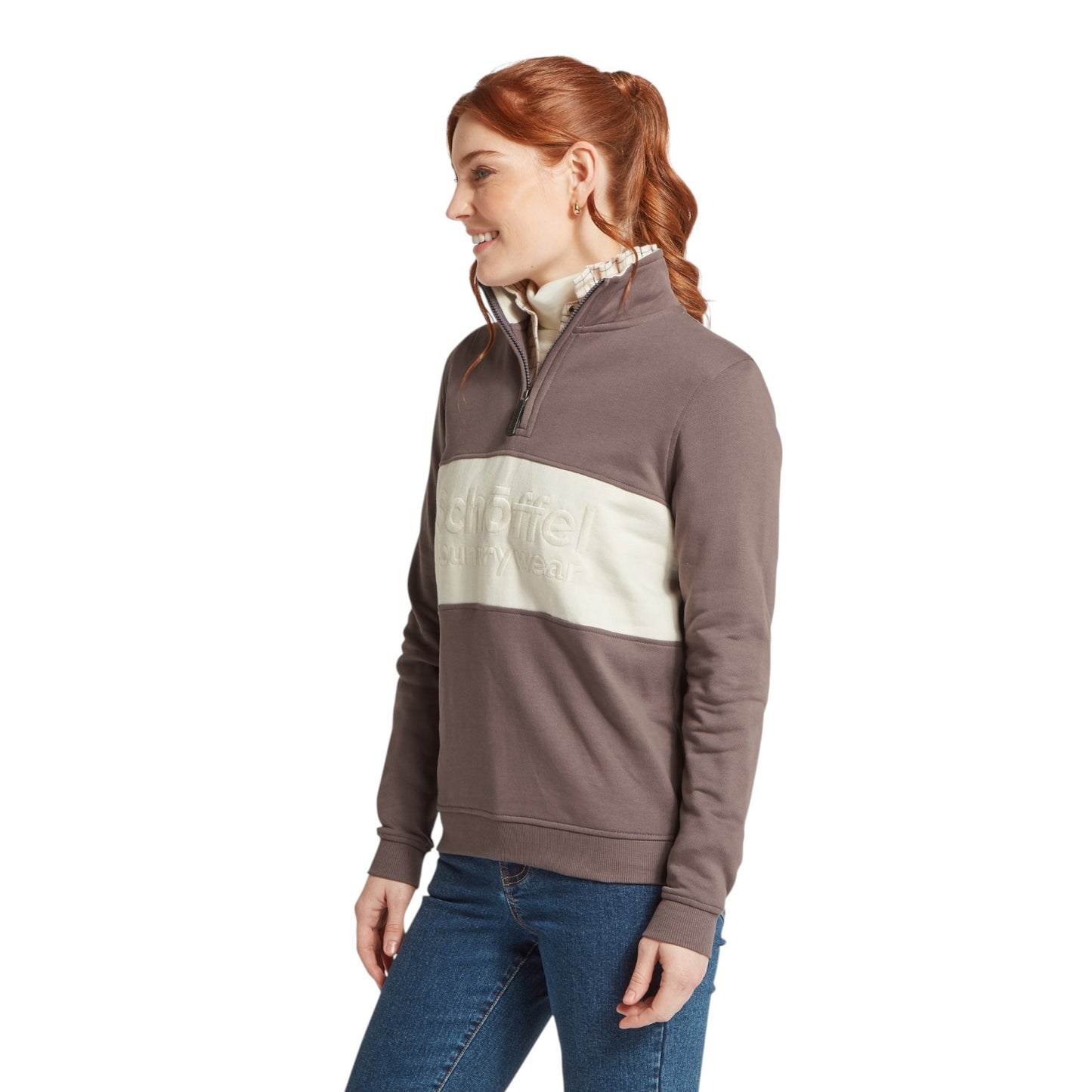 Woman wearing a brown and beige color-blocked pullover with 'Schoffel' branding on a white background.