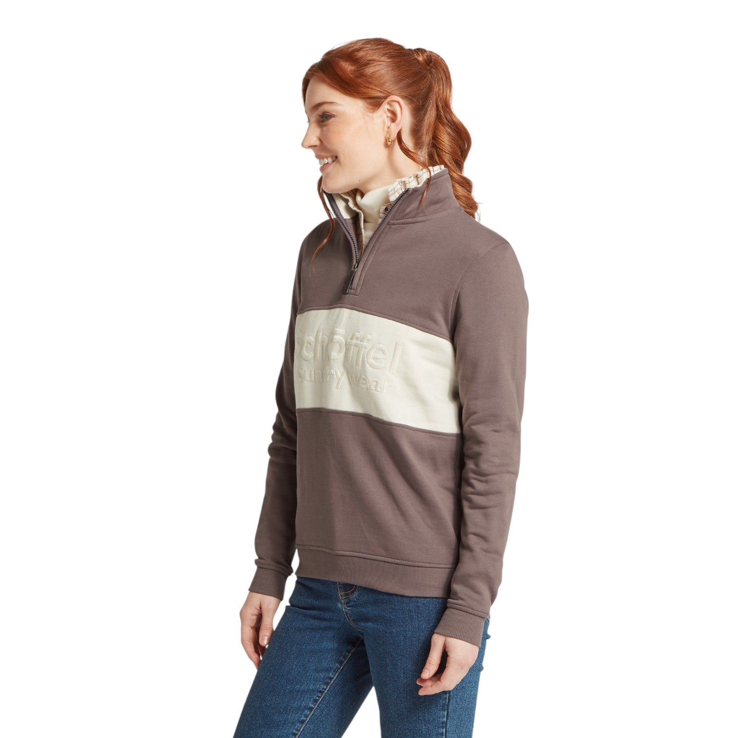 Woman wearing a brown and beige color-blocked pullover with 'Schoffel' branding on a white background.