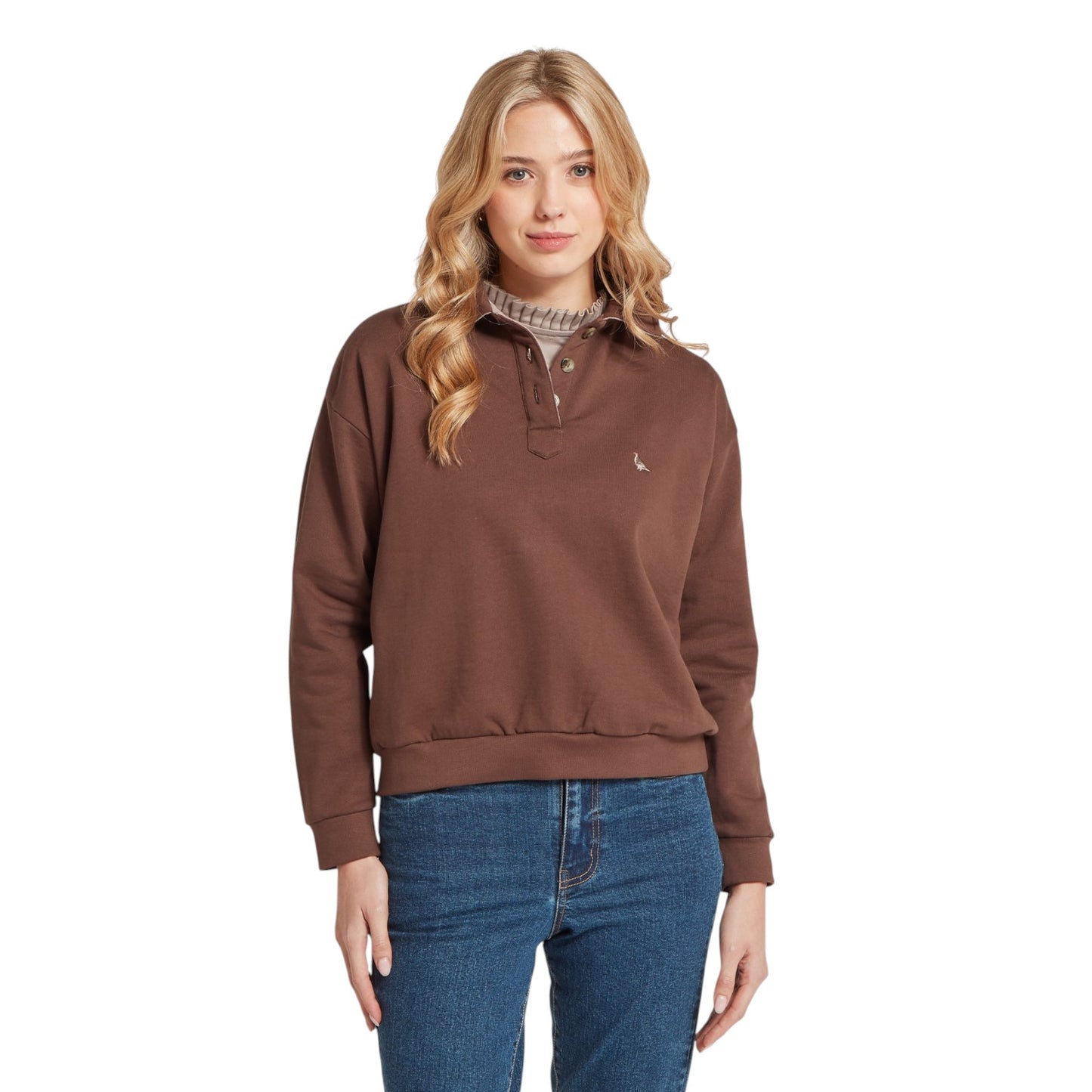 Woman wearing a brown pullover with a visible brand logo on a white background