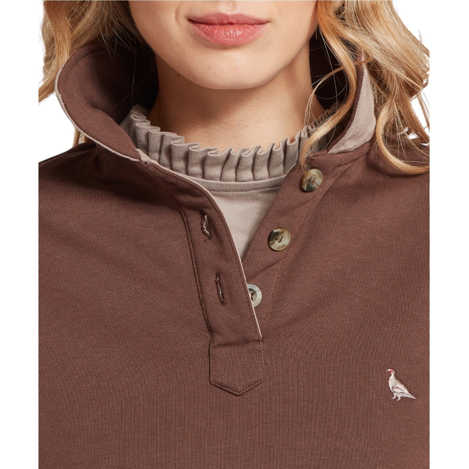 Brown button-up shirt with a small logo on a white background