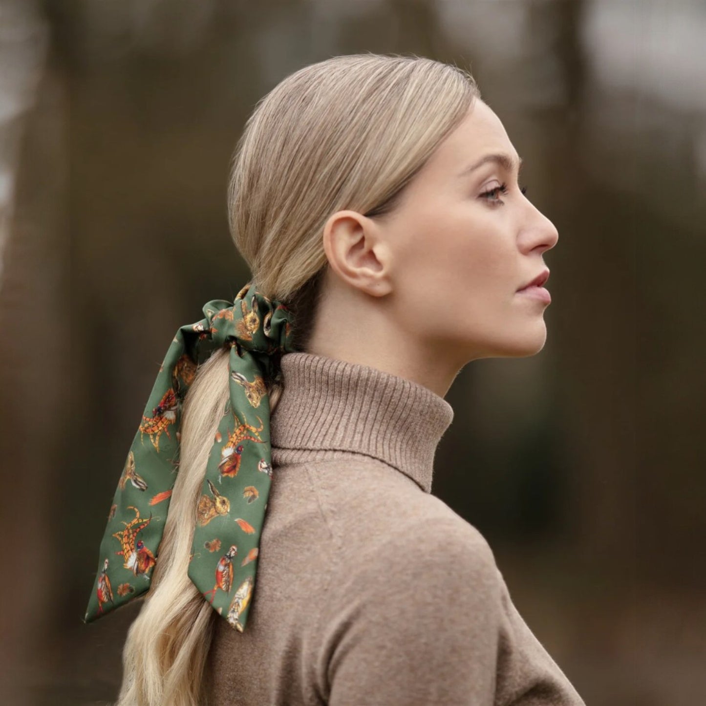 Woman with a patterned hair tie in a forest setting